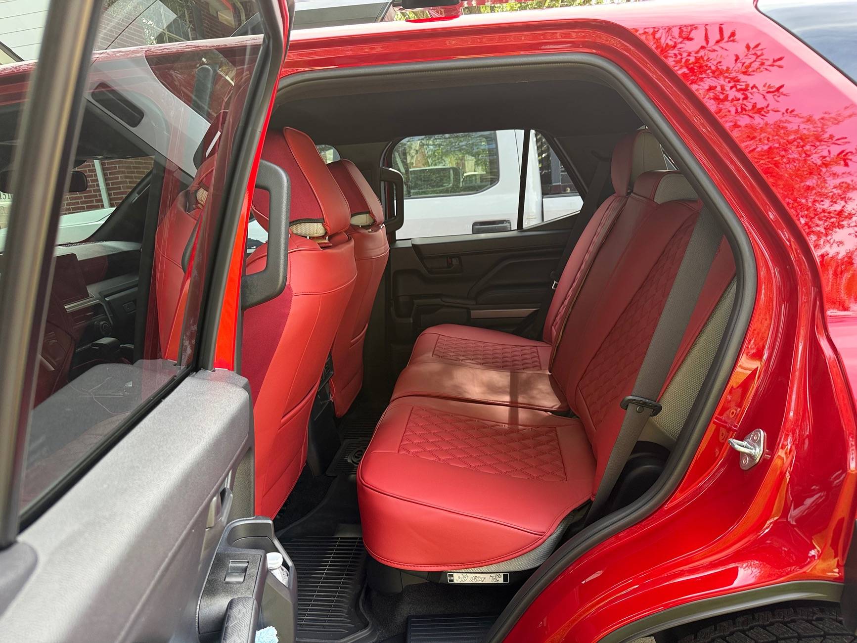 2025 4runner 6th gen First month mods: Bridgestone Dueler A/T RH-S All Terrain 255/75R17 115T, red seat covers and red shackles IMG_8664