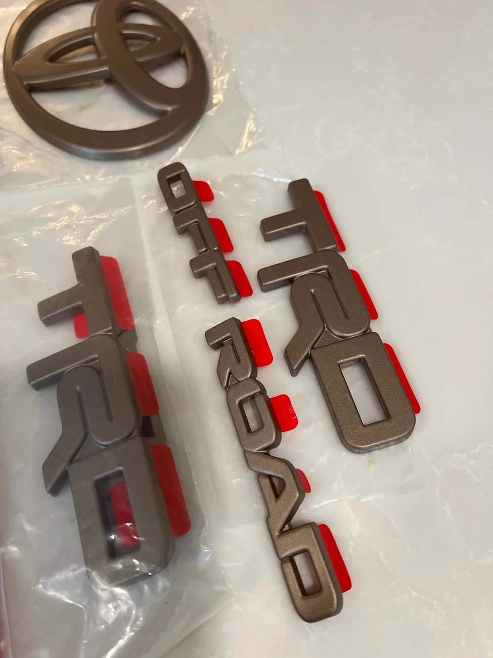 2025 4runner 6th gen WTS - Toyota OEM Bronze Emblem Overlay Kit - TRD Off Road IMG_0485