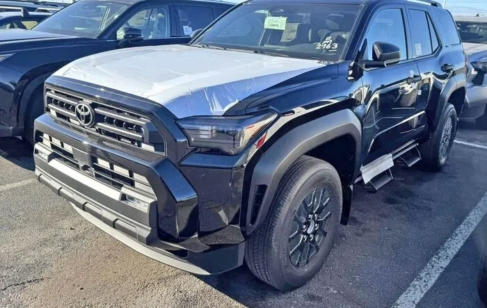 Black SR5 2025 4Runner 6th gen w/ black wheels and Predator tube side steps @ dealership
