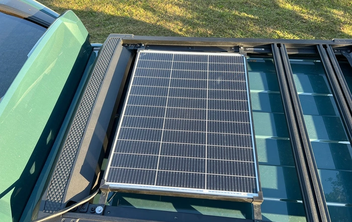 Solar panel installed on roof rack to power a cooler