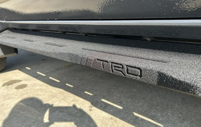 OEM black cast aluminum running boards installed on TRD Pro